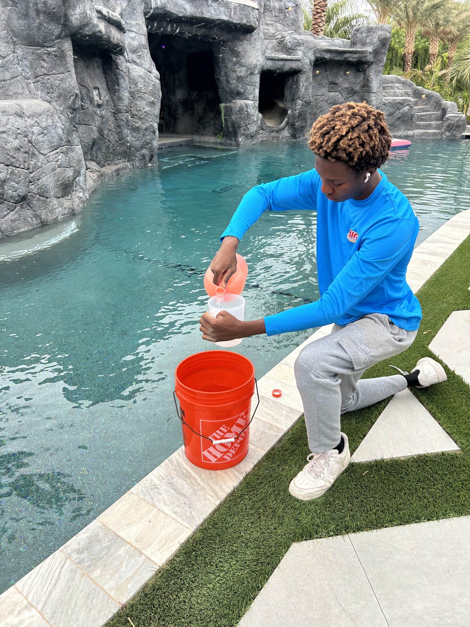 BIG Family Pools technician collecting a water chemistry sample at a grotto pool