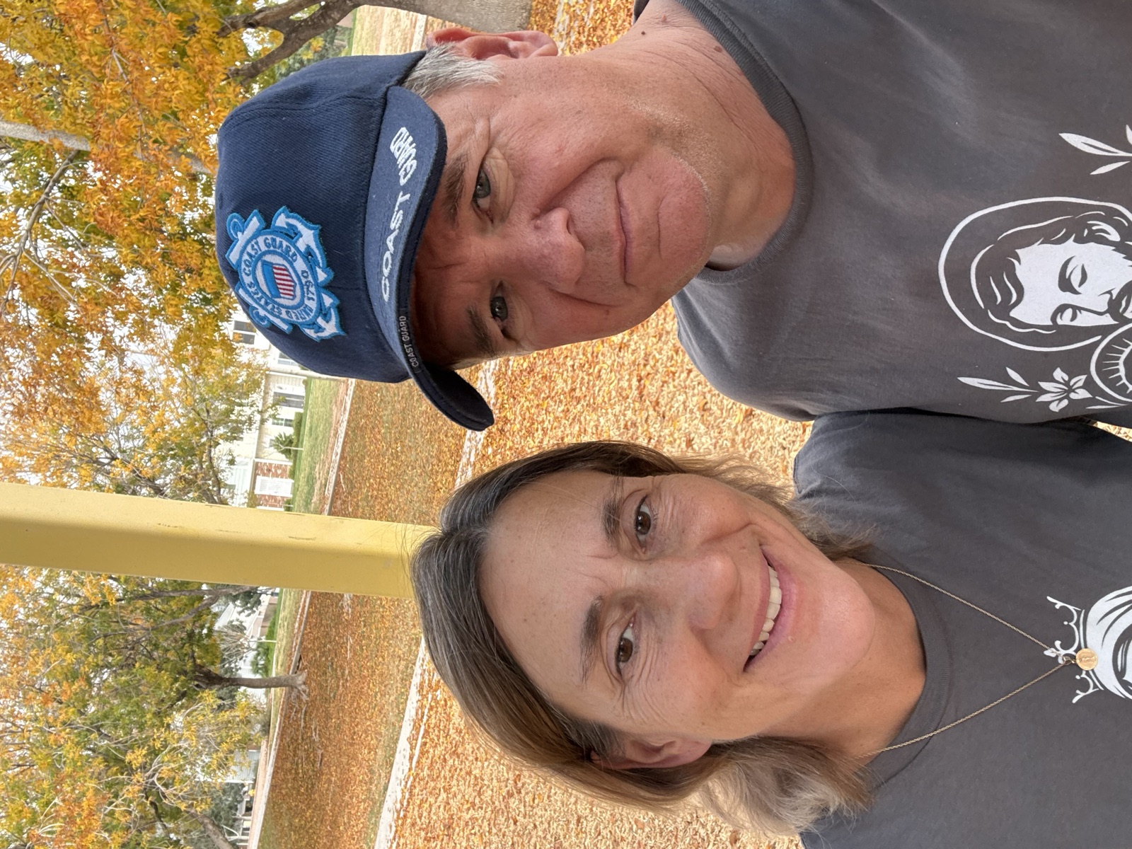 Dean Ouellette in a Coast Guard cap with his wife