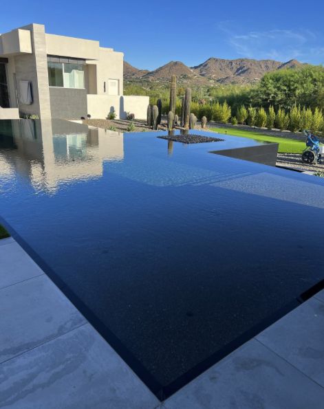 Infinity edge pool with a mountain reflection