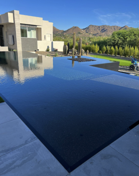 Luxury estate infinity pool with mountain reflection in Scottsdale