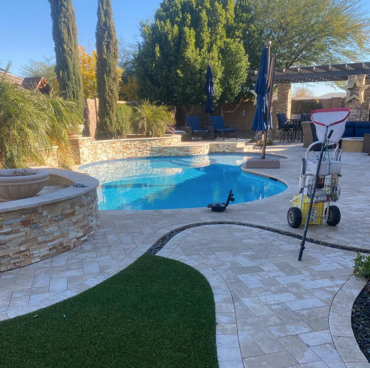 BIG Family Pools service cart on travertine deck at a premium East Valley property